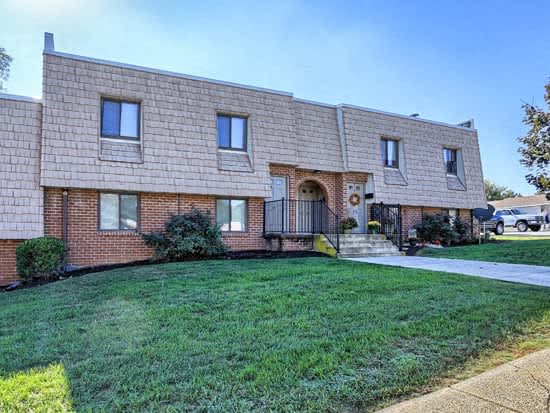 a brick house with a yard in front of it