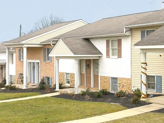 a row of houses in a neighborhood with a lawn