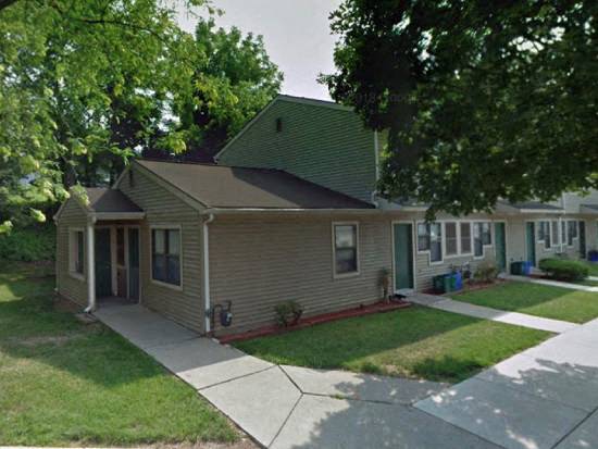 a house with a sidewalk in front of it
