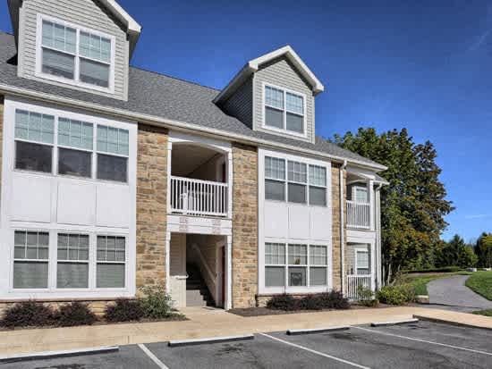 a white house with a balcony and a driveway