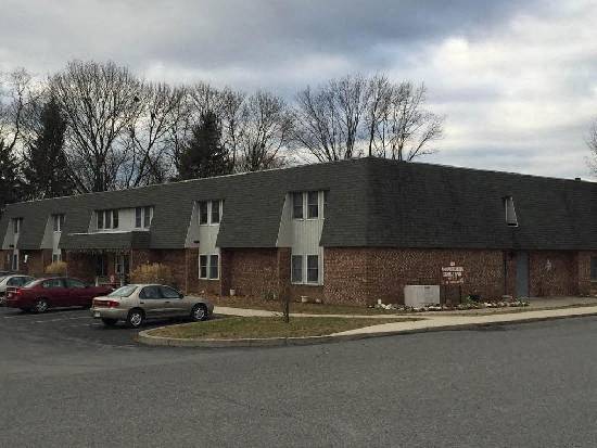 a brick building with cars parked in front of it