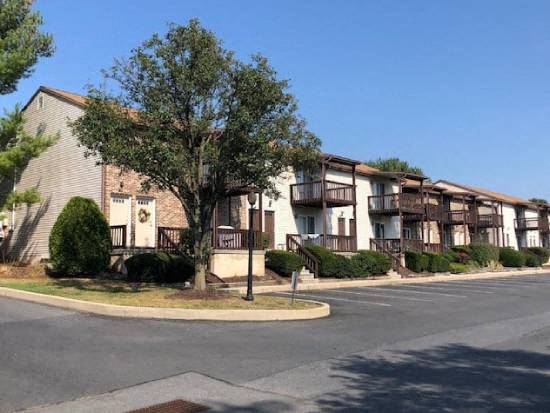 an empty street in front of an apartment building