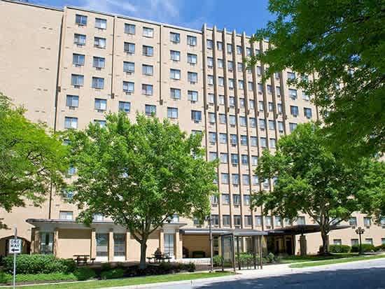 a large building with trees in front of it