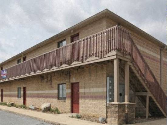 a brick building with a wooden balcony