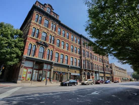 a large brick building on the corner of a city street