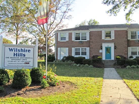 a house with a wilshire hills sign in front of it