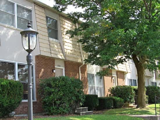 a lamp post in front of a brick house