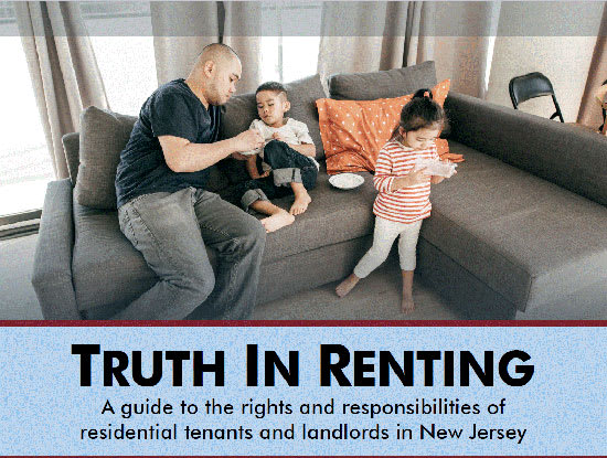 A family is sitting on a couch with a sign that reads "Truth in Renting" in front of them.