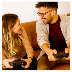 A man and a woman are playing a video game together.