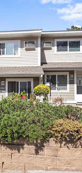 A house with a white picket fence in front.