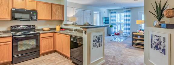 A kitchen with wooden cabinets and a black stove top oven.