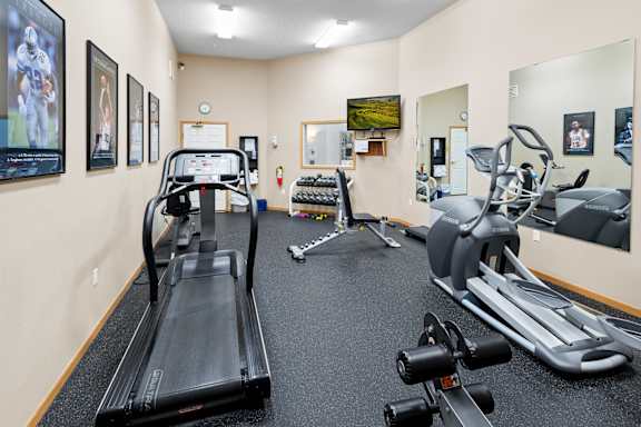 A gym with treadmills, weights, and exercise bikes.