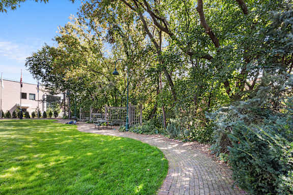 A green park with a winding brick walkway.