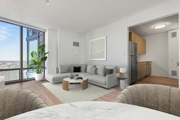 A modern living room with a large window overlooking the city.