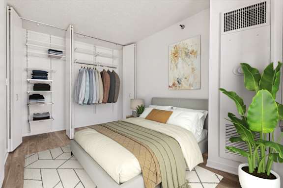 A bedroom with a bed, a wardrobe, and a plant.