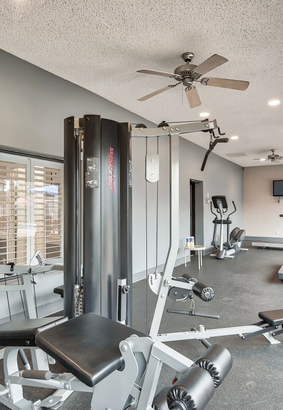 a gym with exercise machines and a ceiling fan at Randolph Park, Charlotte, NC