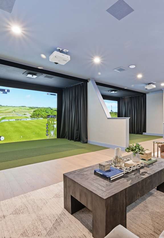 a lounge area with couches and a coffee table in front of a pool