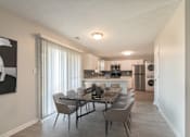 Thumbnail 1 of 8 - A modern dining room with a table set for six.
