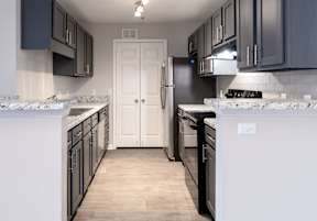 an empty kitchen with a sink and cabinets  at Lakeside on Riverwatch in Martinez, GA