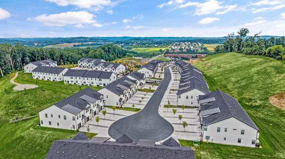 A large, modern housing development with a curved road running through it.