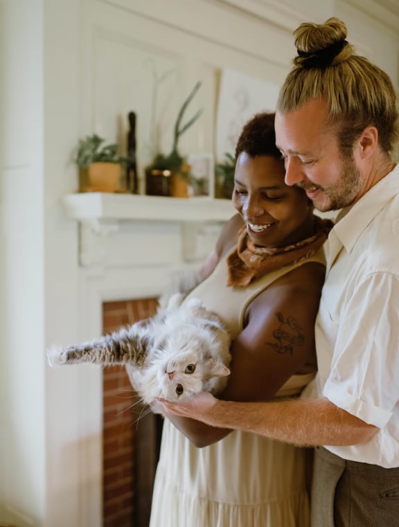 a bride and groom hold their dog