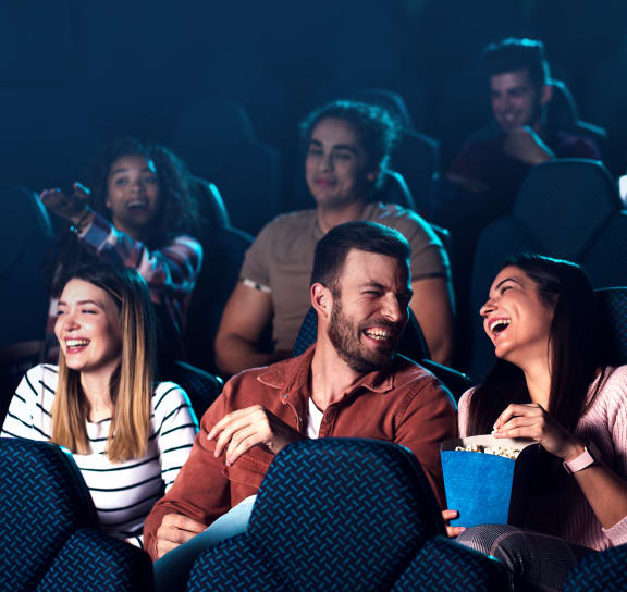 a group of people laughing in a movie theater
