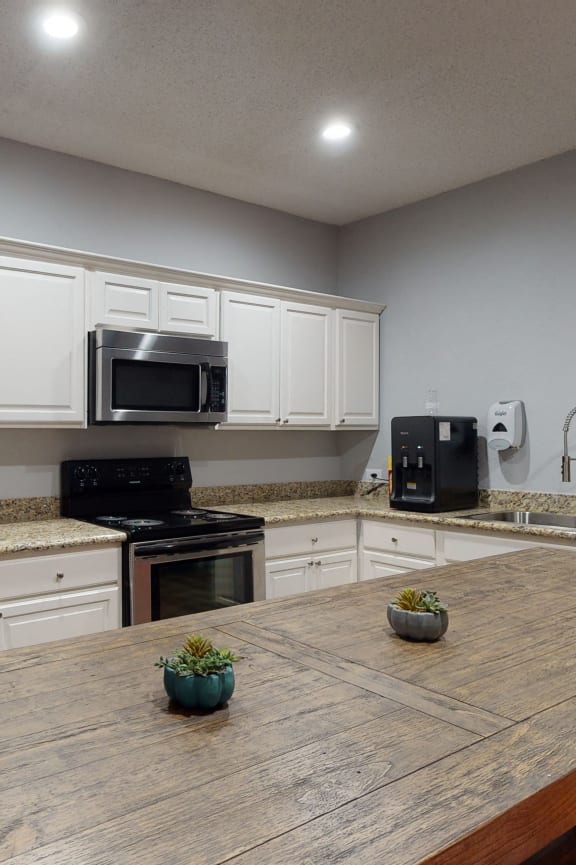 a kitchen with wooden cabinets and a black microwave