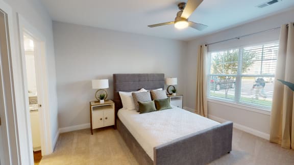 a bedroom with a bed and a ceiling fan