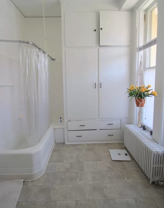 a bathroom with a bathtub and a window