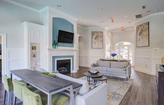 A modern living room with a fireplace and a television.