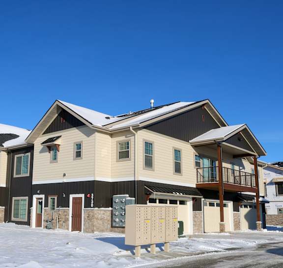 A row of houses with snow on the ground.