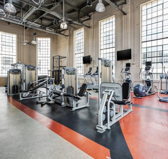 a gym with cardio machines and weights