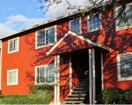 A red building with a white door and windows.