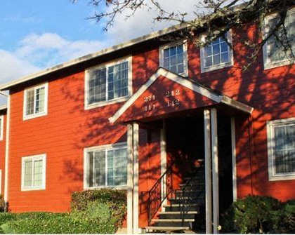 A red building with a white door and windows.