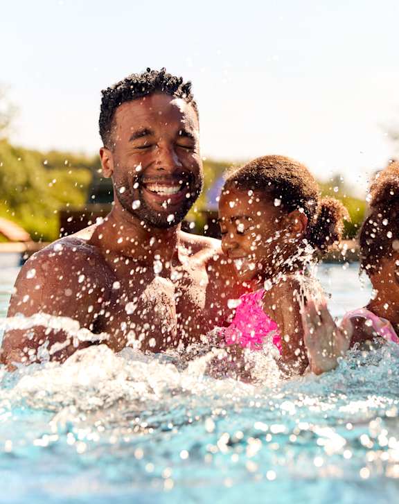 a family playing in a swimming pool