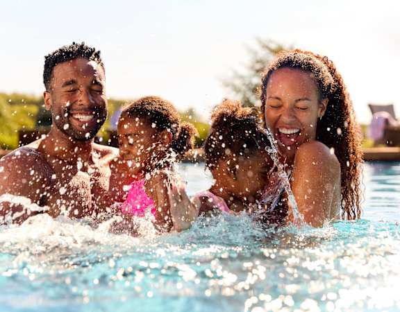 a family playing in a swimming pool