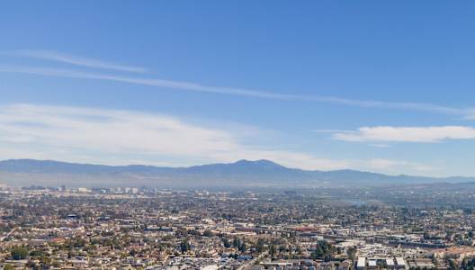 A cityscape with a clear blue sky above. at Hamilton Courtyard Apartments, Costa Mesa, 92627