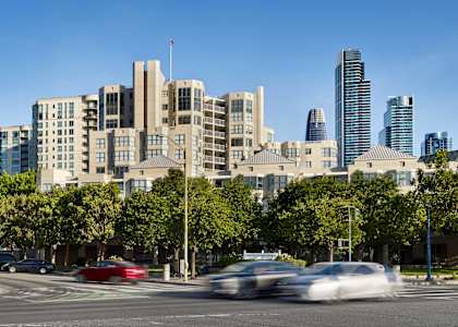 A city street with cars and buildings in the background.