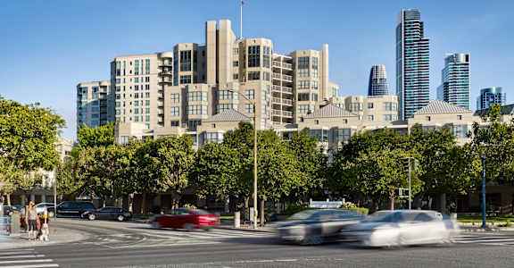 A city street with cars and buildings in the background.