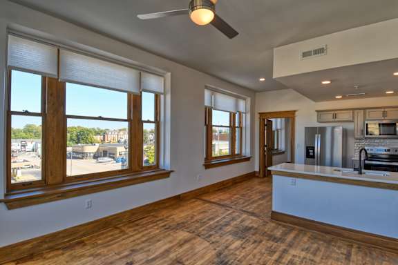 A room with wooden floors and a ceiling fan.