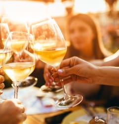 people toasting wine glasses at a restaurant