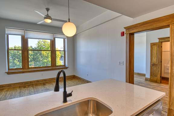 A room with wooden floors and a large window.