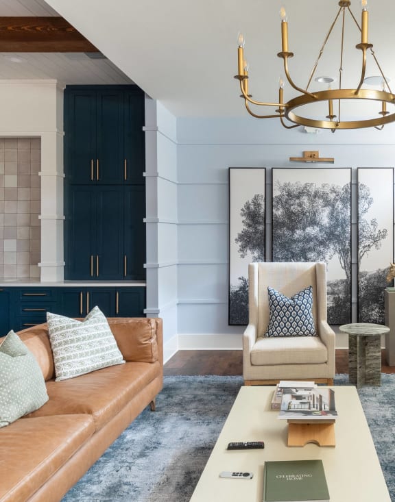a living room with a brown leather couch and a tv