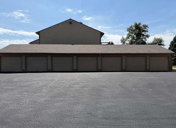 Fox Run Apartments garage building in Omaha, Nebraska with a gray exterior and garage door