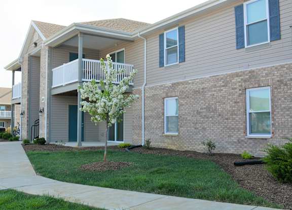 a building with a balcony and a tree in front of it  at Hawthorne Properties in Lafayette, IN 47905