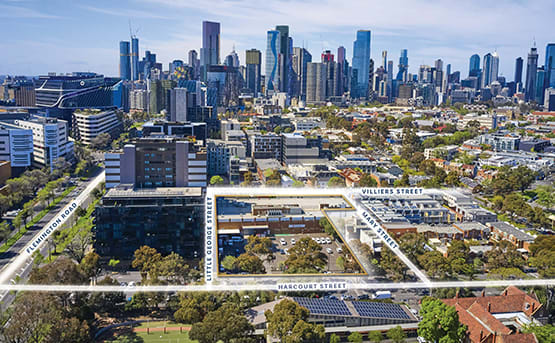 an aerial view of the university of melbourne with the city in the background