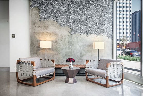 an empty living room with a fireplace and wood flooring at OLiVE DTLA in Los Angeles, California