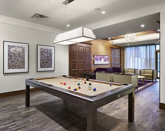 play a game of pool in our game room at our apartments