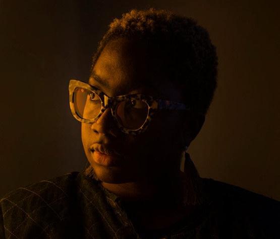 a portrait of a woman wearing glasses