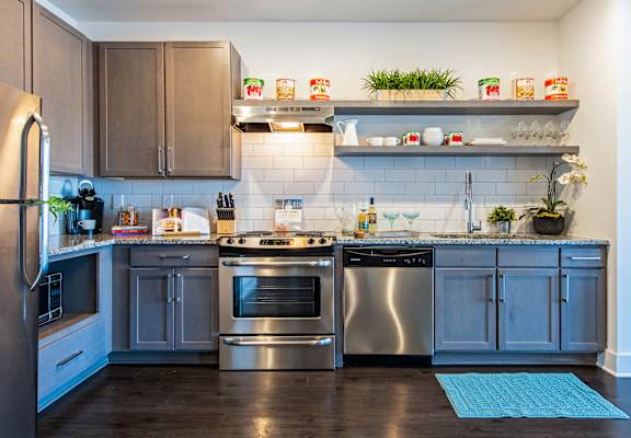 A kitchen with a refrigerator, stove, and oven.